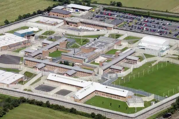An aerial view of Long Lartin Prison surrounded by lush greenery.