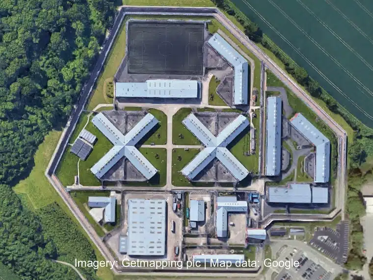 Aerial view of Lowdham Grange Prison, with its multiple buildings and secure enclosures.