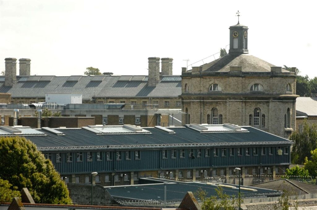 Front view of Maidstone Prison's main entrance, with its imposing brick walls. Alt Image Title: Maidstone Prison in Kent